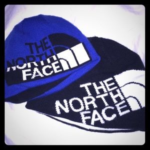 A pair of North face toddler winter hats.